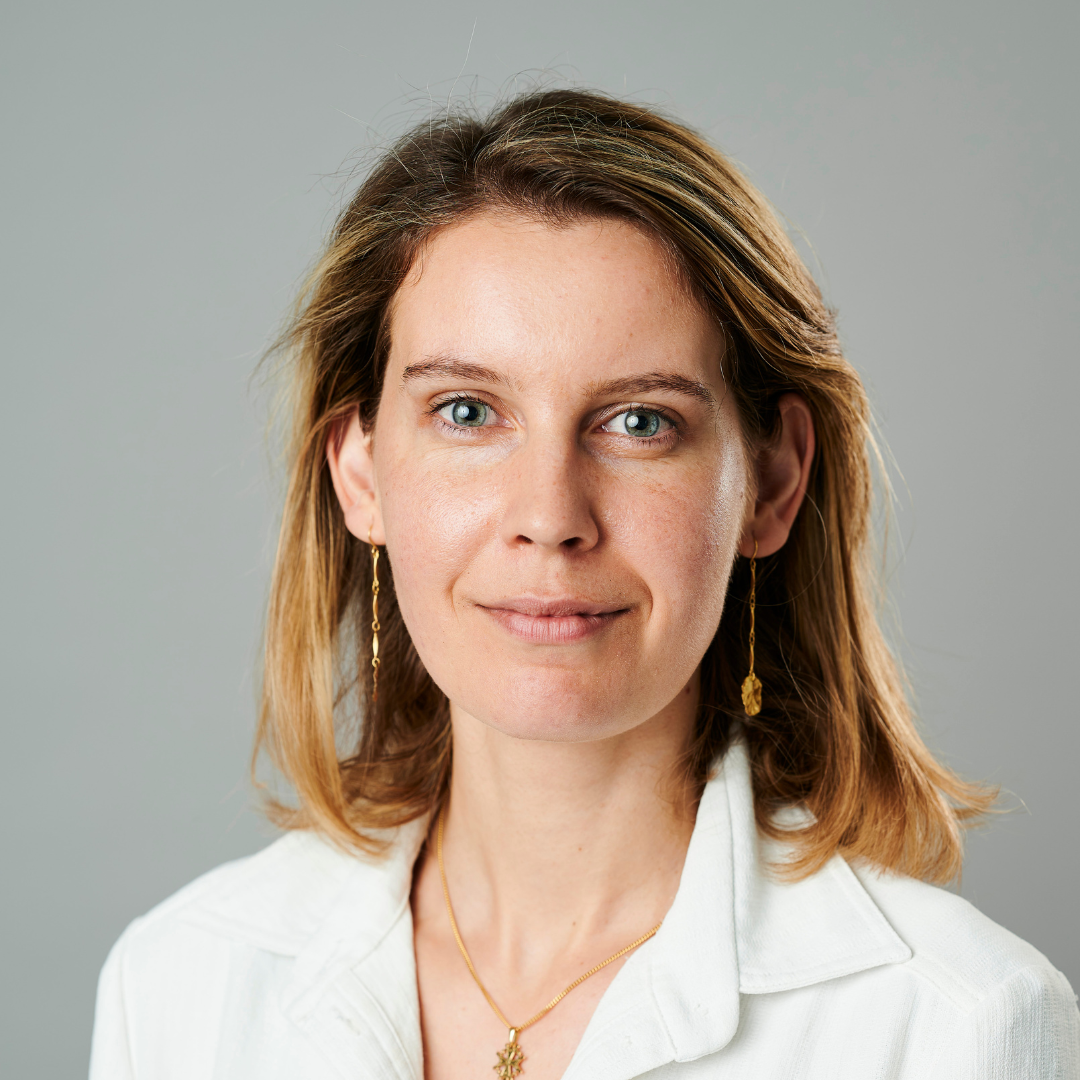 Woman wearing a white shirt smiling at camera